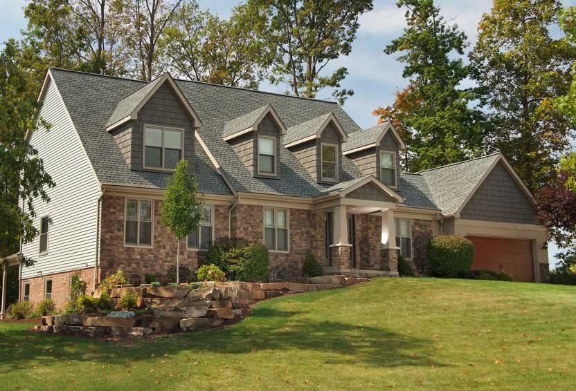 Stone-and-siding home addition by Tamer Construction